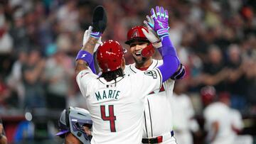 Mar 28, 2024; Phoenix, Arizona, USA; Arizona Diamondbacks left fielder Lourdes Gurriel Jr. (12) slaps hands with Arizona Diamondbacks second baseman Ketel Marte (4) after hitting a two run home run against the Colorado Rockies during the first inning at Chase Field. Mandatory Credit: Joe Camporeale-USA TODAY Sports