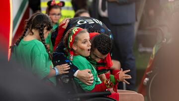 Portugal�s forward #7 Cristiano Ronaldo hugs a child in a wheelchair before the UEFA Nations League football match, group A, between Portugal and Scotland at Luz stadium in Lisbon on September 8, 2024. (Photo by Patricia DE MELO MOREIRA / AFP)