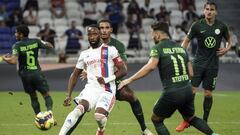 Lyon&#039;s Moussa Dembele, center, challenges for the ball with Wolfsburg&#039; players during their friendly soccer match in Decines, near Lyon, central France, Saturday, July 17, 2021. (AP Photo/Laurent Cipriani)