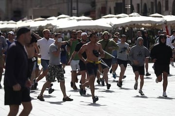 Russian fans run at England fans as they clash ahead of the game against Russia later today on June 11, 2016 in Marseille,