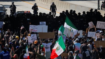 Demonstrators block the highway, as law enforcement officers stand facing them, during a protest against federal immigration sweeps in downtown Los Angeles, California, U.S. June 8, 2025. REUTERS/Mike Blake