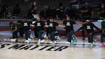 Aug 19, 2020; Lake Buena Vista, Florida, USA; Coaches and players kneel during the national anthem before game two of the first round of the 2020 NBA Playoffs between the Utah Jazz and the Denver Nuggets at AdventHealth Arena. Mandatory Credit: Kim Klement-USA TODAY Sports