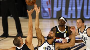 LAKE BUENA VISTA, FLORIDA - AUGUST 25: Rudy Gobert #27 of the Utah Jazz and Nikola Jokic #15 of the Denver Nuggets battle for possession at tip-off in Game Five of the Western Conference First Round during the 2020 NBA Playoffs at The Field House at ESPN 