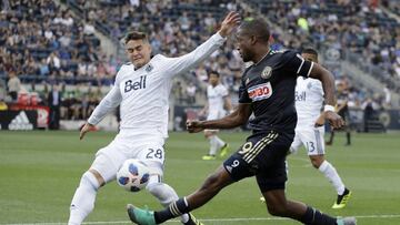 Philadelphia Union's Fafa Picault (9) tries to get the ball past Vancouver Whitecaps's Jake Nerwinski (28) during the first half of an MLS soccer match, Saturday, June 23, 2018, in Chester, Pa. (AP Photo/Matt Slocum)