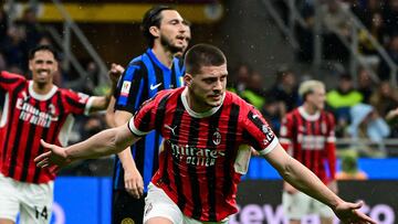 AC Milan's Serbian forward #09 Luka Jovic (C) celebrates after scoring AC Milan's first goal during the Coppa Italia second leg semi-final football match between Inter Milan and AC Milan at the San Siro stadium in Milan on April 23, 2025. (Photo by Piero CRUCIATTI / AFP)