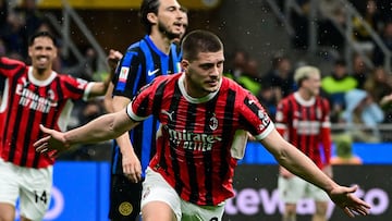 AC Milan's Serbian forward #09 Luka Jovic (C) celebrates after scoring AC Milan's first goal during the Coppa Italia second leg semi-final football match between Inter Milan and AC Milan at the San Siro stadium in Milan on April 23, 2025. (Photo by Piero CRUCIATTI / AFP)