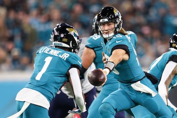 Jan 7, 2023; Jacksonville, Florida, USA;  Jacksonville Jaguars quarterback Trevor Lawrence (16) hands off to running back Travis Etienne Jr. (1) against the Tennessee Titans in the first quarter at TIAA Bank Field. Mandatory Credit: Nathan Ray Seebeck-USA TODAY Sports