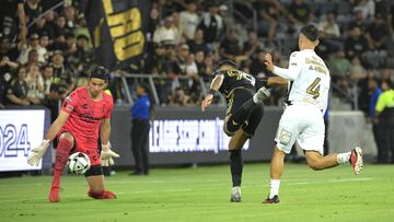 Jul 26, 2024; Los Angeles, California, USA; LAFC forward Denis Bouanga (99) takes the ball past Club Tijuana defender Nicolas Andres Diaz Huincales (4) and shoots past Club Tijuana goalkeeper Jose Antonio Rodriguez Romero (2) but hits the post in the second half at BMO Stadium. Mandatory Credit: Jayne Kamin-Oncea-USA TODAY Sports