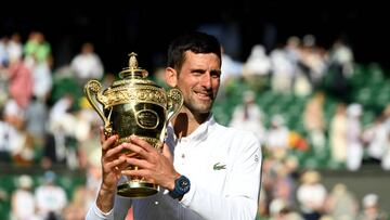LONDON, ENGLAND - JULY 10: Gentlemen's Singles Final Novak Djokovic (SRB) v Nick Kyrgios (AUS) - Novak Djokovic celebrates victory by holding the trophy during day fourteen of The Championships Wimbledon 2022 at All England Lawn Tennis and Croquet Club on July 10, 2022 in London, England. (Photo by Stringer/Anadolu Agency via Getty Images)