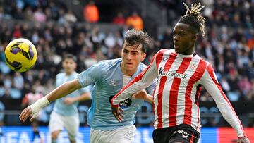 Celta Vigo's Spanish defender #32 Javier Rodriguez Galiano (L) and Athletic Bilbao's Spanish forward #10 Nico Williams vie for the ball during the Spanish league football match between RC Celta de Vigo and Athletic Club Bilbao at the Balaidos stadium in Vigo, on January 19, 2025. (Photo by MIGUEL RIOPA / AFP)
