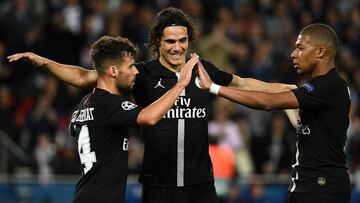 Paris Saint-Germain's Spanish defender Juan Bernat (L), Paris Saint-Germain's Uruguayan forward Edinson Cavani and Paris Saint-Germain's French forward Kylian Mbappe react following a goal during their UEFA Champions' League football m