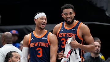 Josh Hart #3 and Karl-Anthony Towns #32 of the New York Knicks smile near the bench in the fourth quarter against the Washington Wizards at Capital One Arena on December 30, 2024 in Washington, DC.