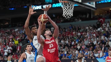 Giannis Antetokounmpo, de Grecia, trata de frenar a Alperen Sengun, de Turquía.