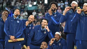 Gold medallists (From L) USA's #05 Anthony Edwards, USA's #09 Tyrese Haliburton, USA's #08 Derrick White, USA's #10 Jayson Tatum, USA's #06 LeBron James, USA's #11 Joel Embiid, USA's #13 Bam Adebayo, USA's #14 Anthony Davis and USA's #15 Devin Booker pose on the podium after the men's Gold Medal basketball match between France and USA during the Paris 2024 Olympic Games at the Bercy Arena in Paris on August 10, 2024. (Photo by Damien MEYER / AFP)