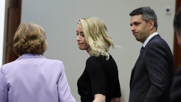 Actor Amber Heard looks to her lawyer Elaine Bredehoft after the jury said that they believe she defamed ex-husband Johnny Depp.