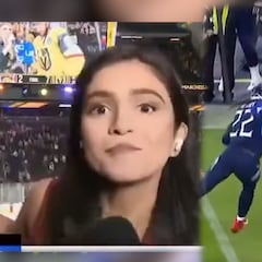 Reporter stiff arms guy trying to get in front of the camera at hockey game