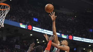 Dec 12, 2016; Toronto, Ontario, CAN; Milwaukee Bucks forward Giannis Antetokounmpo (34) shoots for a basket over Toronto Raptors forward Patrick Patterson at Air Canada Centre. The Raptors won 122-100. Mandatory Credit: Dan Hamilton-USA TODAY Sports