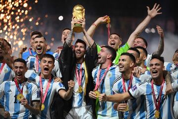 Lionel Messi lifts the World Cup trophy during the Qatar 2022 World Cup trophy ceremony 