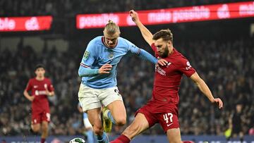 Liverpool's English defender Nathaniel Phillips (R) tackles Manchester City's Norwegian striker Erling Haaland during the English League Cup fourth round football match between Manchester City and Liverpool, at the Etihad stadium in Manchester on December 22, 2022. (Photo by Oli SCARFF / AFP) / RESTRICTED TO EDITORIAL USE. No use with unauthorized audio, video, data, fixture lists, club/league logos or 'live' services. Online in-match use limited to 120 images. An additional 40 images may be used in extra time. No video emulation. Social media in-match use limited to 120 images. An additional 40 images may be used in extra time. No use in betting publications, games or single club/league/player publications. / 