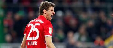 Bayern Munich's Thomas Mueller celebrates after scoring the 1-0 lead during the German Bundesliga soccer match between Borussia Moenchengladbach and Bayern Munich at the Borussia-Park stadium in Moenchengladbach,