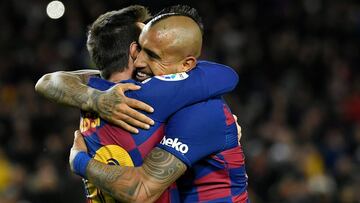 Barcelona's Argentine forward Lionel Messi (L) is congratulated by Barcelona's Chilean midfielder Arturo Vidal for scoring the opening goal during the Spanish league football match between FC Barcelona and Granada FC at the Camp Nou stadium in Barcelona on January 19, 2020. (Photo by LLUIS GENE / AFP)