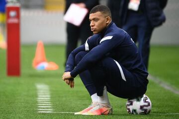 France's forward Kylian Mbappe sits on a ball during warm up prior to starting on the bench for the FIFA World Cup Qatar 2022 qualification Group D football match between Kazakhstan and France, at the Astana Arena, in Nur-Sultan, on March 28, 2021. (Photo