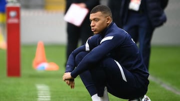 France's forward Kylian Mbappe sits on a ball during warm up prior to starting on the bench for the FIFA World Cup Qatar 2022 qualification Group D football match between Kazakhstan and France, at the Astana Arena, in Nur-Sultan, on March 28, 2021. (Photo