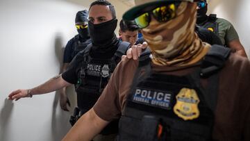 A migrant is detained by federal immigration officers at U.S. immigration court in Manhattan, in New York City, U.S., July 24, 2025. REUTERS/David 'Dee' Delgado