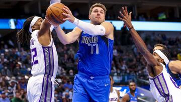 Oct 31, 2021; Dallas, Texas, USA;  Dallas Mavericks guard Luka Doncic (77) shoots past Sacramento Kings center Richaun Holmes (22) during the first quarter at American Airlines Center. Mandatory Credit: Kevin Jairaj-USA TODAY Sports