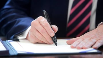 FILE PHOTO: U.S. President Donald Trump signs the Paycheck Protection Program and Health Care Enhancement Act financial response to the coronavirus disease (COVID-19) outbreak, in the Oval Office at the White House in Washington, U.S. April 24, 2020. REU