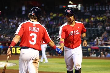Great Britain catcher Harry Ford (right) celebrates with teammate Jaden Rudd after scoring in the fourth inning single against Colombia.