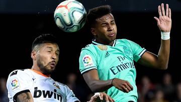 Valencia's Argentinian defender Ezequiel Garay (L) heads the ball next to Real Madrid's Brazilian forward Rodrygo during the Spanish League football match between Valencia CF and Real Madrid, at the Mestalla stadium in Valencia, on December 15,