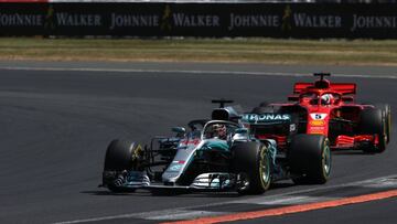 NORTHAMPTON, ENGLAND - JULY 08: Lewis Hamilton of Great Britain driving the (44) Mercedes AMG Petronas F1 Team Mercedes WO9 leads Sebastian Vettel of Germany driving the (5) Scuderia Ferrari SF71H on track during the Formula One Grand Prix of Great Britain at Silverstone on July 8, 2018 in Northampton, England.  (Photo by Charles Coates/Getty Images)