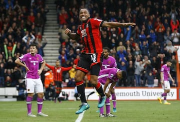 Performing against the odds: Callum Wilson jumps for joy after scoring Bournemouth's sixth goal against Hull