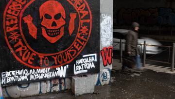 BELGRADE, SERBIA - JANUARY 20: A pedestrian walks past a mural depicting the logo of the Russian mercenary 'Group Wagner' and a slogan in Russian by the informal pro-Russia organisation 'Narodna Patrola (lit.: People Patrol), on January 20, 2023 in Belgrade, Serbia. President Aleksandar Vucic of Serbia condemned the private paramilitary group Wagner after the mercenary unit published classified ads in local media attempting to recruit Serbs to fight for Russia in Ukraine. (Photo by Srdjan Stevanovic/Getty Images)