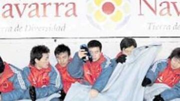 <b>POCO PÚBLICO Y MUCHO FRÍO. </b>A falta de goles y juego de calidad, el frío fue el gran protagonista del partido de anoche en el Reyno de Navarra entre las selecciones navarra y china. En la imagen, el banquillo chino con los jugadores arropados con mantas para combatir la invernal temperatura.