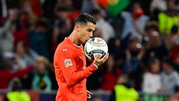 Portugal's forward #07 Cristiano Ronaldo kisses the ball after scoring the 2-2 equaliser during the UEFA Nations League final football match between Portugal and Spain in Munich, southern Germany on June 8, 2025. (Photo by John MACDOUGALL / AFP)