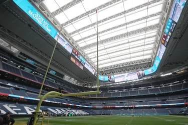 Workers install the posts on each side of the field at the Bernabéu stadium.