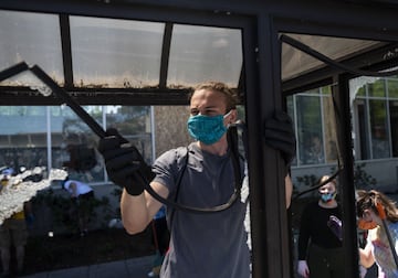 MINNEAPOLIS, MN - MAY 30: People work to clean up destroyed bus stop on May 30, 2020 in Minneapolis, Minnesota. Buildings and businesses around the Twin Cities have been looted and destroyed in the fallout after the death of George Floyd while in police custody. Police Officer Derek Chauvin has been charged with third-degree murder and manslaughter in Floyd's death. Stephen Maturen/Getty Images/AFP == FOR NEWSPAPERS, INTERNET, TELCOS & TELEVISION USE ONLY ==