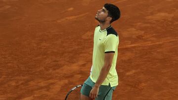 Spain's Carlos Alcaraz reacts as he plays against Russia's Andrey Rublev during the 2024 ATP Tour Madrid Open tournament quarter-final tennis match at Caja Magica in Madrid on May 1, 2024. (Photo by PIERRE-PHILIPPE MARCOU / AFP)