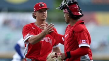SAN JUAN, PUERTO RICO - MARCH 11: Adam MacKo #64 of Team Canada shakes hands with teammate Bo Naylor #23 after pitching against the Team Cuba in the sixth inning during the 2026 World Baseball Classic at Hiram Bithorn Stadium on March 11, 2026 in San Juan, Puerto Rico. Al Bello/Getty Images/AFP (Photo by AL BELLO / GETTY IMAGES NORTH AMERICA / Getty Images via AFP)