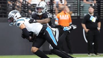 LAS VEGAS, NEVADA - SEPTEMBER 22: Adam Thielen #19 of the Carolina Panthers scores a touchdown as Jack Jones #18 of the Las Vegas Raiders looks to make a tackle during the second quarter at Allegiant Stadium on September 22, 2024 in Las Vegas, Nevada. Ian Maule/Getty Images/AFP (Photo by Ian Maule / GETTY IMAGES NORTH AMERICA / Getty Images via AFP)