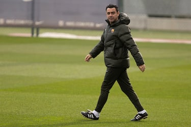 How many titles has Xavi won with Barcelona as a coach and as a player?