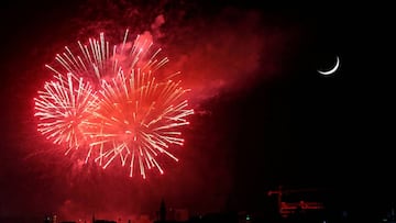 Fireworks light up the sky above the Abdali Boulevard, next to the crescent moon, during a celebration of the country's 74th Independence Day within a limited number of activities amid the spread of the coronavirus disease (COVID-19), in Amman, Jorda