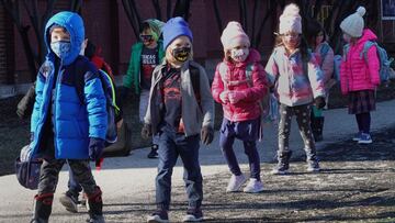 CHICAGO, ILLINOIS - MARCH 01: Students are escorted from Hawthorne Scholastic Academy to meet their parents following their first day of in-person learning on March 01, 2021 in Chicago, Illinois. Students in kindergarten through fifth grade began in-perso