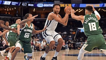 MEMPHIS, TENNESSEE - OCTOBER 05: Kyle Anderson #1 of the Memphis Grizzlies handles the ball against Justin Robinson #55 of the Milwaukee Bucks in the third quarter during the preseason game at FedExForum on October 05, 2021 in Memphis, Tennessee. NOTE TO