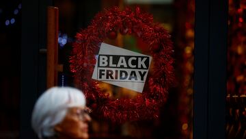 A woman walks past a Black Friday sale sign on a shop window in Nantes, France, November 26, 2024. REUTERS/Stephane Mahe