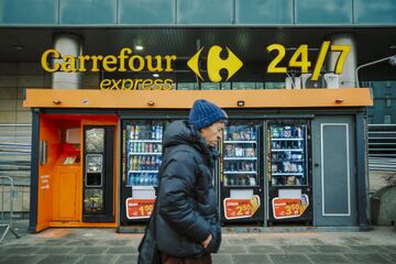 A pedestrian passes Carrefour Express vending machines on a street in Warsaw, Poland, on Wednesday, Jan. 4, 2022. Poland left borrowing costs unchanged as the threat of an economic recession overshadows concerns over the highest inflation in more than a quarter century. Photographer: Damian Lemaski/Bloomberg via Getty Images