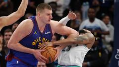 Denver Nuggets center Nikola Jokic (15) fouls Minnesota Timberwolves guard Monte Morris (23) in the third quarter at Target Center.