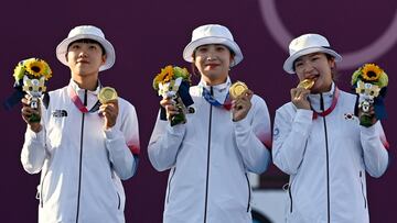 25 July 2021, Japan, Tokyo: South Korea's An San, Jang Minhee, Kang Chaeyoung celebrate with their gold medals on the podium during the medal ceremony of the women's team archery event at Yumenoshima Park Archery Field during the Tokyo 2020 Olym